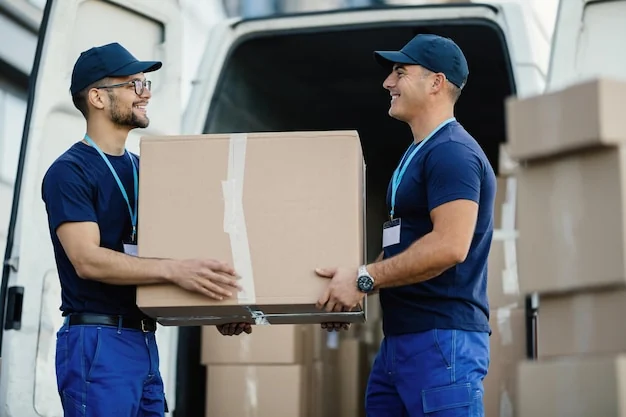 Verhuisbedrijven – verhuizers dragen dozen bij de verhuiswagen